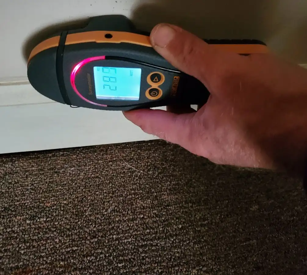 Moisture detection at baseboard during Storm Damage Restoration in Gardere
